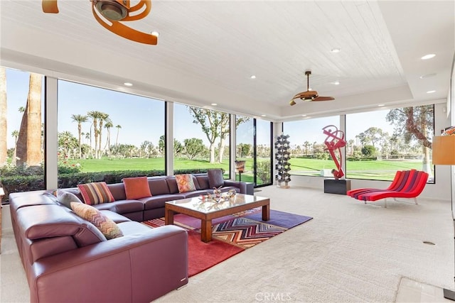 sunroom with a tray ceiling, wood ceiling, and ceiling fan