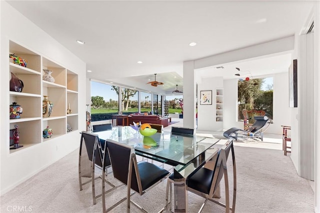 dining room with plenty of natural light, recessed lighting, built in shelves, and carpet floors