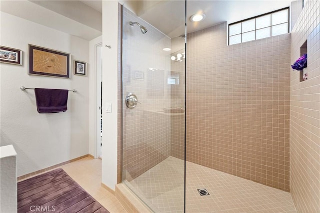 bathroom with baseboards and walk in shower