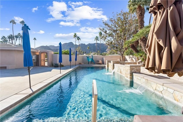 view of pool with a patio area, a fenced in pool, fence, and a mountain view