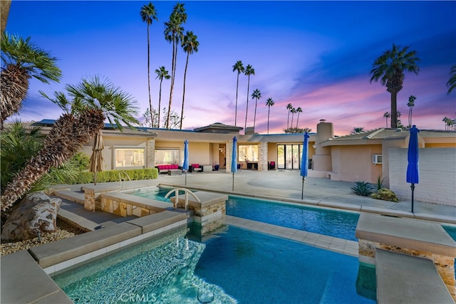 70854 Fairway Dr, Rancho Mirage, CA 92270 - pool at dusk with a pool with connected hot tub and a patio