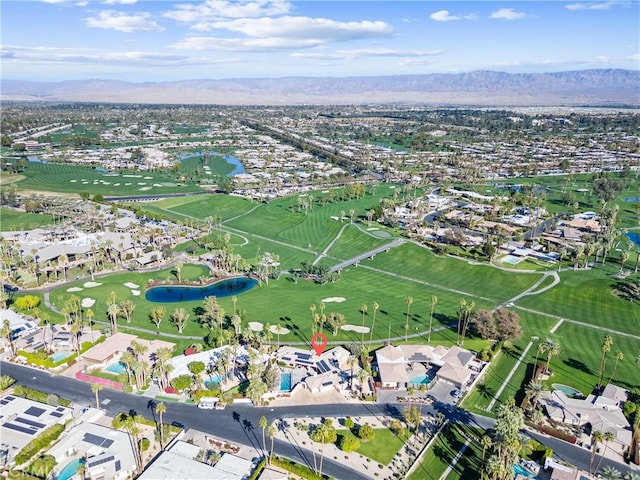 drone / aerial view with a mountain view and golf course view