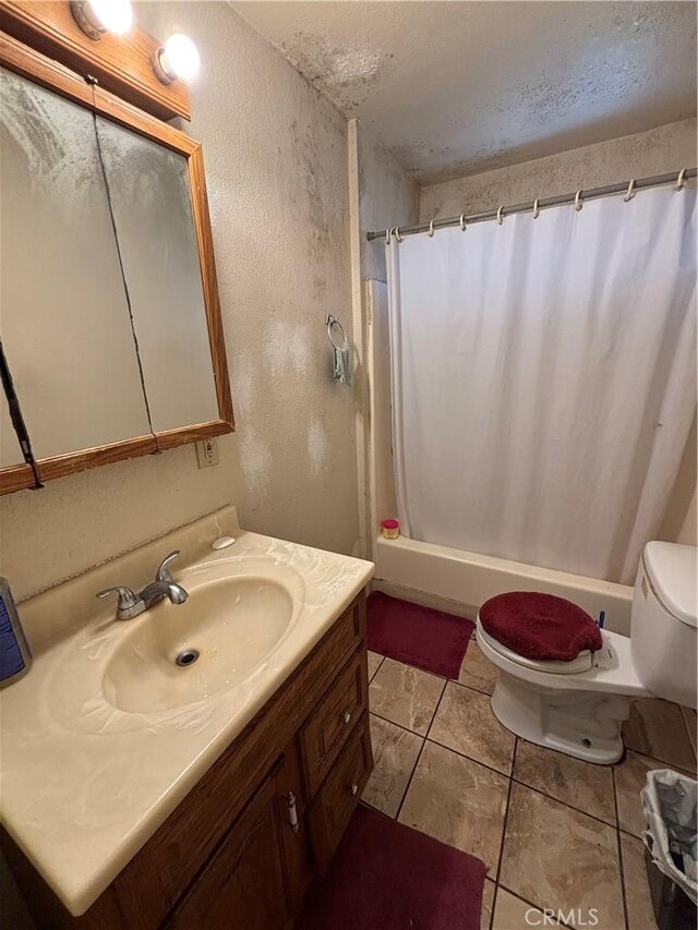 full bathroom with toilet, a textured ceiling, tile patterned floors, shower / bath combo, and vanity