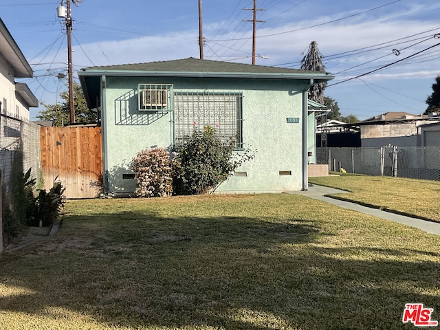 view of side of home with a lawn