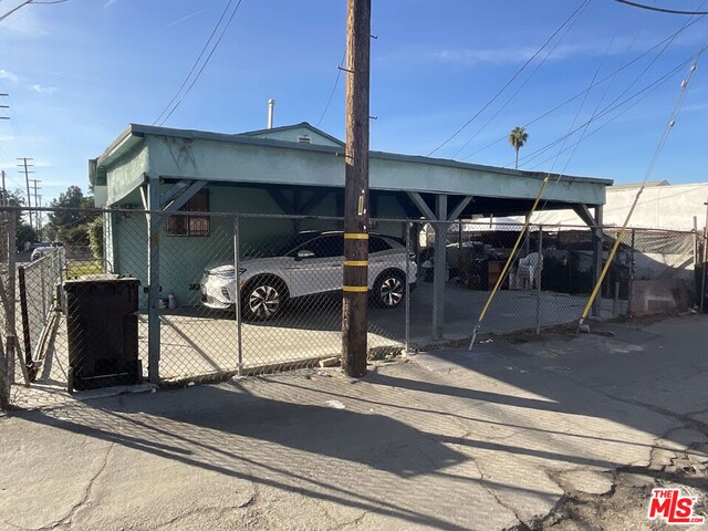 view of parking / parking lot featuring a carport