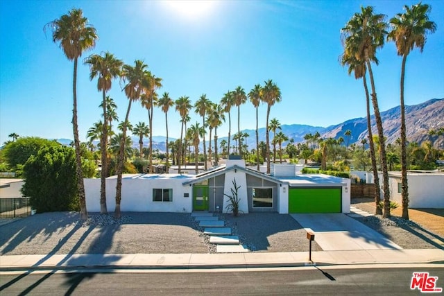 view of front of property featuring a garage and a mountain view