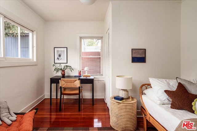 interior space featuring dark hardwood / wood-style flooring and ornamental molding