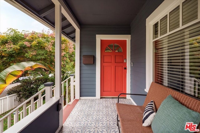 entrance to property featuring covered porch