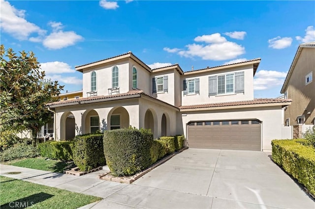 mediterranean / spanish house featuring a garage