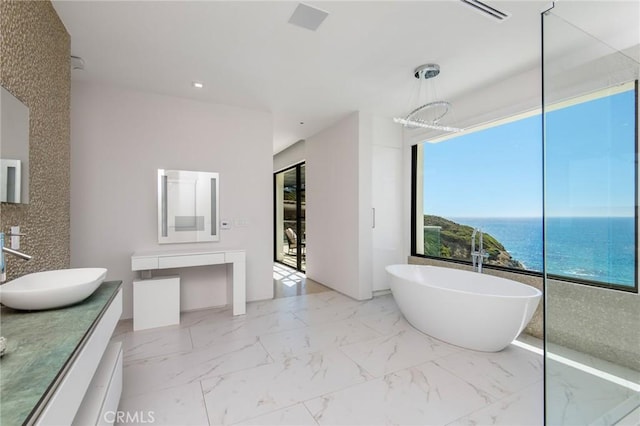 bathroom with a water view, a bathing tub, a notable chandelier, and vanity