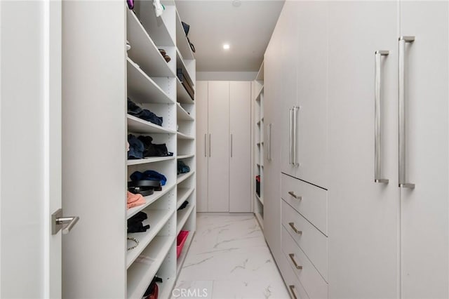 spacious closet with marble finish floor