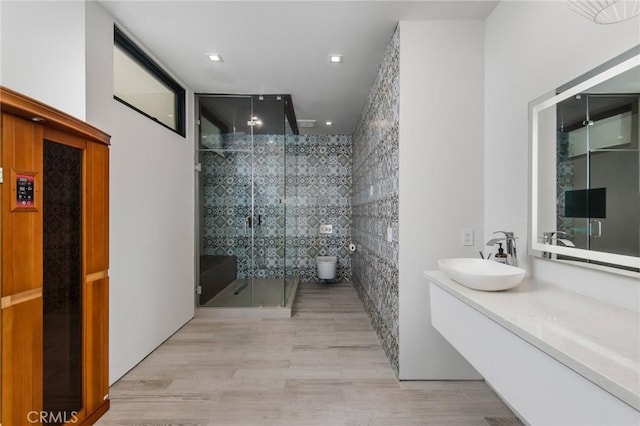 bathroom with elevator, toilet, an enclosed shower, and vanity