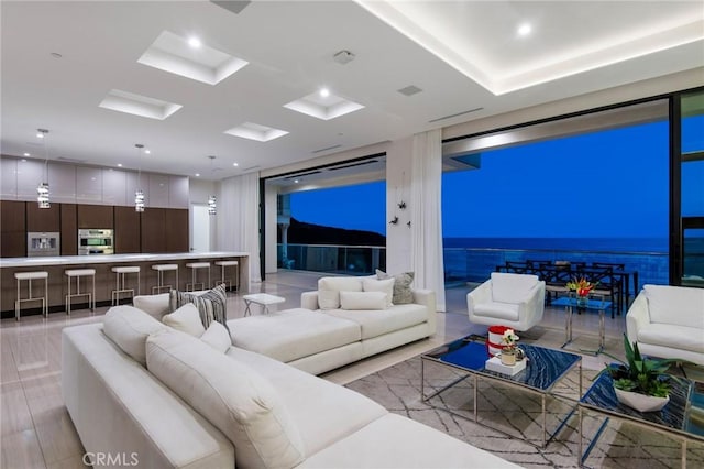 living room featuring recessed lighting and floor to ceiling windows