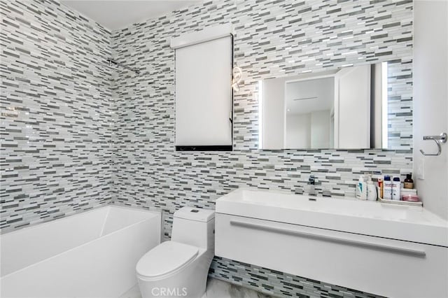 full bathroom featuring toilet, tile walls, vanity, a tub, and tasteful backsplash