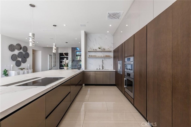 kitchen with visible vents, a sink, and modern cabinets