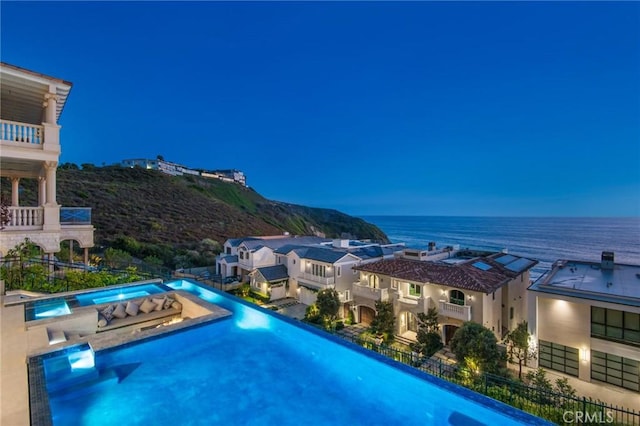 view of pool featuring a water view