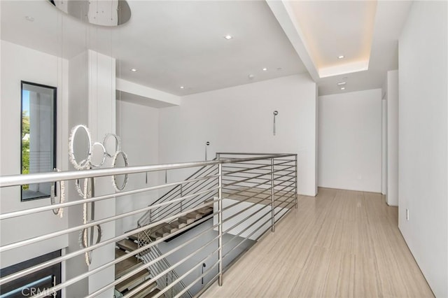 hallway featuring recessed lighting and an upstairs landing