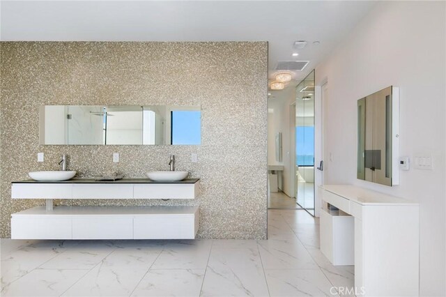 bathroom with tasteful backsplash and vanity