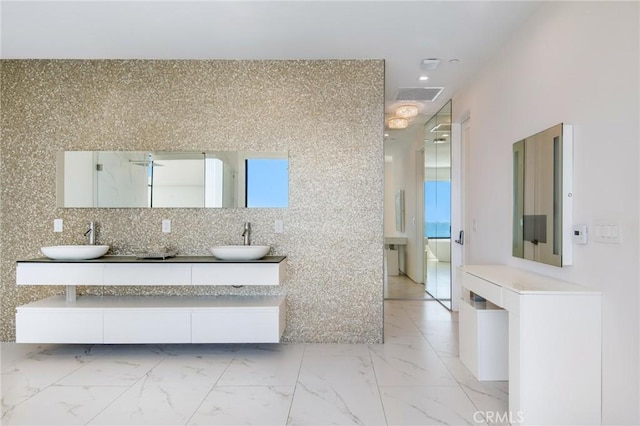 full bathroom with double vanity, marble finish floor, visible vents, and a sink