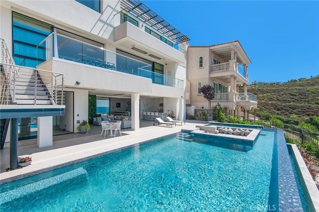 view of swimming pool featuring fence, an outdoor hangout area, a fenced in pool, and a patio