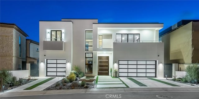 modern home featuring a balcony and a garage