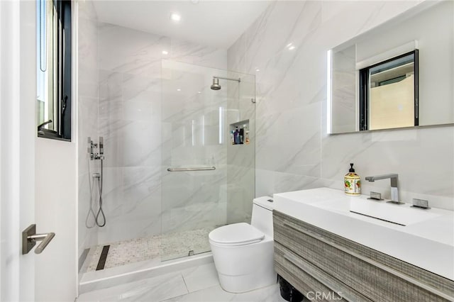 bathroom featuring toilet, a marble finish shower, tile walls, and vanity