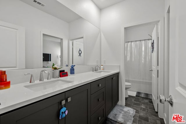 full bathroom with toilet, vanity, and shower / tub combo with curtain