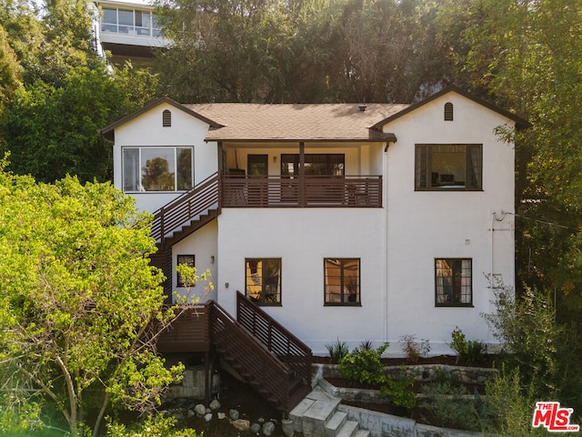 rear view of property featuring a balcony