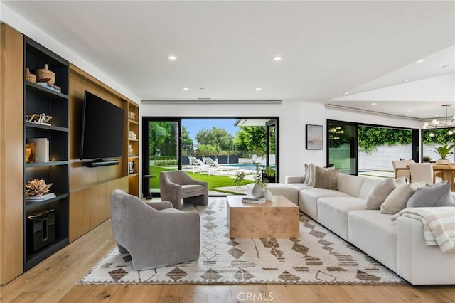 living room featuring light hardwood / wood-style floors and built in shelves