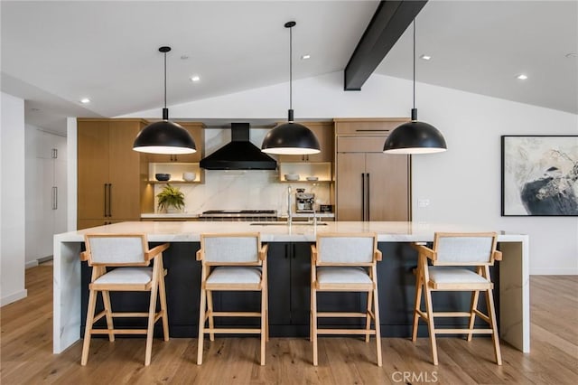 kitchen with decorative light fixtures, sink, custom range hood, and lofted ceiling with beams