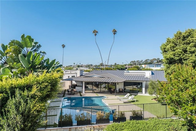 view of pool featuring a patio area and a yard