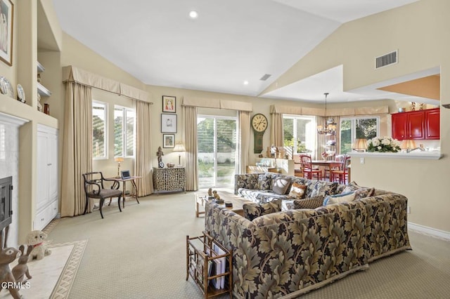 living room with light carpet, vaulted ceiling, and a notable chandelier