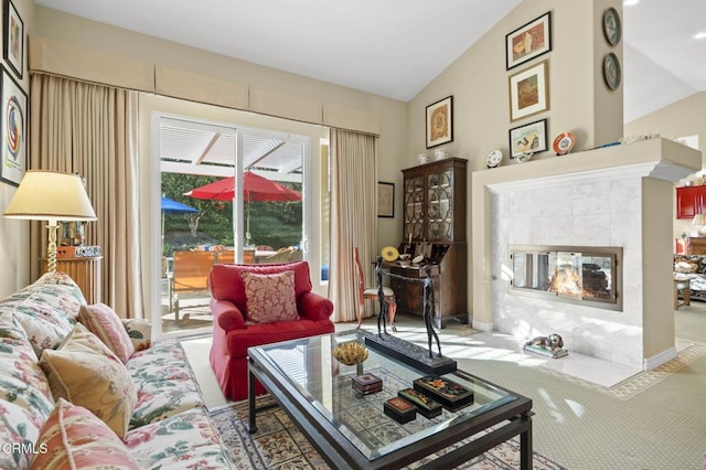 carpeted living room with lofted ceiling and a tile fireplace