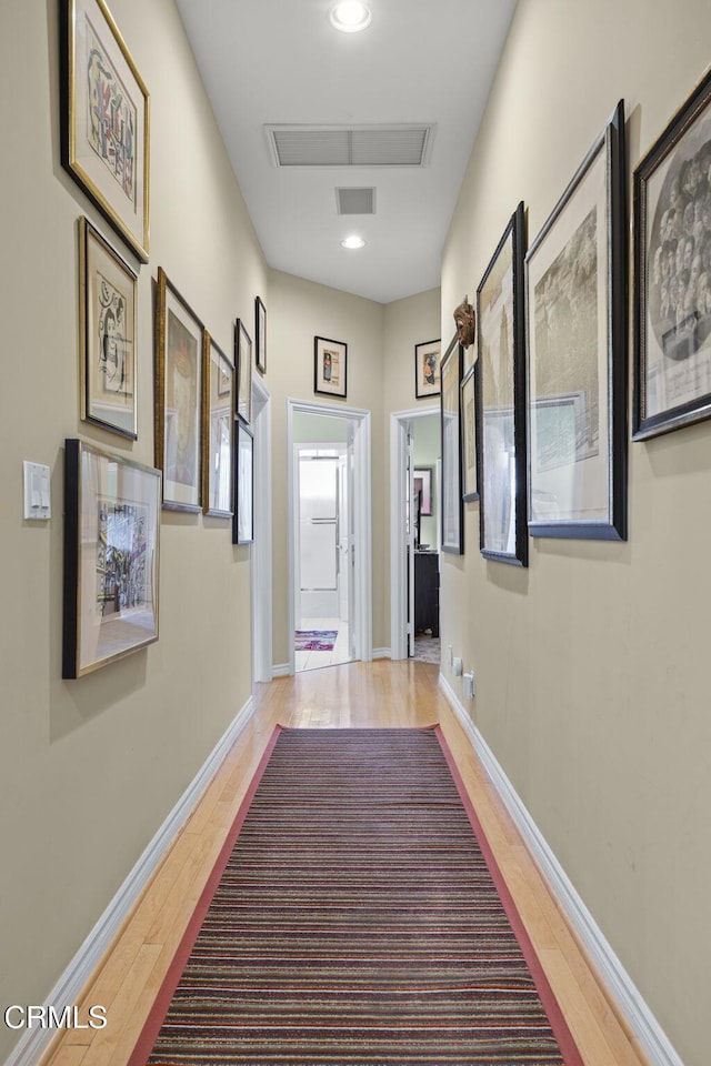 corridor featuring hardwood / wood-style floors