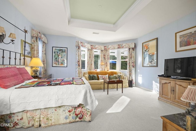 carpeted bedroom with a raised ceiling and ornamental molding