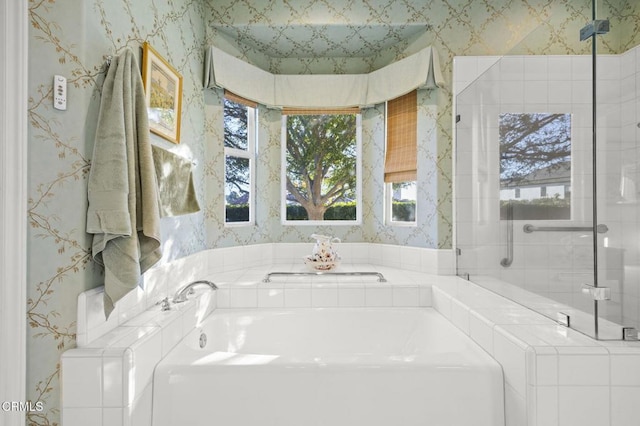 bathroom featuring a tub and washer / dryer