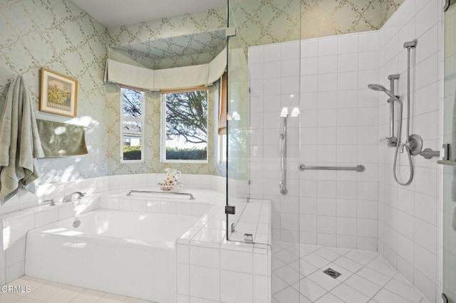 bathroom with independent shower and bath and tile patterned flooring