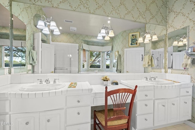 bathroom featuring walk in shower, a notable chandelier, and vanity