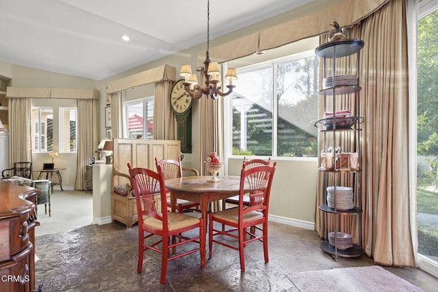 dining space featuring a wealth of natural light, lofted ceiling, and a notable chandelier