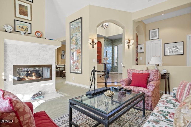 carpeted living room with a tile fireplace