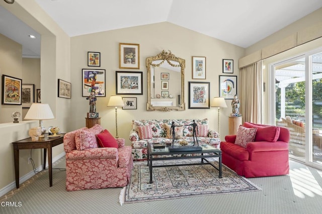 sitting room with lofted ceiling and carpet flooring