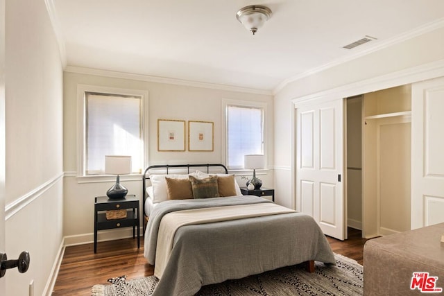 bedroom with dark hardwood / wood-style flooring and ornamental molding