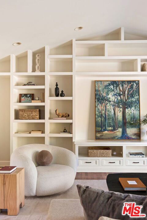 sitting room with lofted ceiling