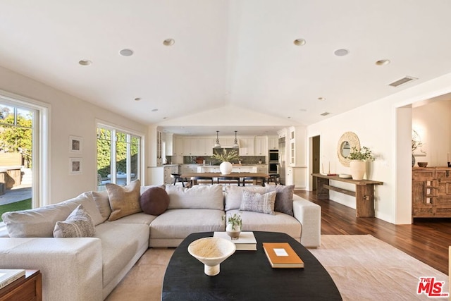 living room with lofted ceiling and light hardwood / wood-style floors