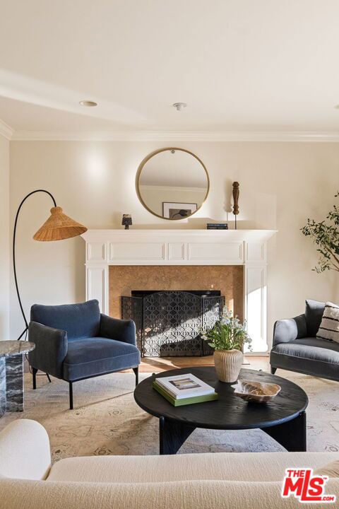 interior space with a premium fireplace and crown molding