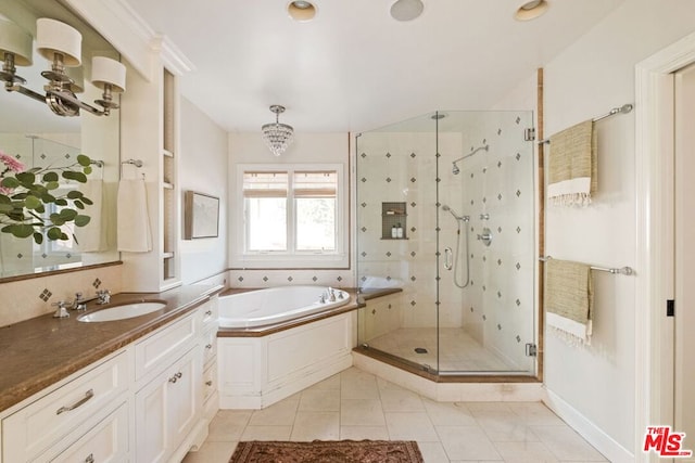 bathroom with vanity, tile patterned flooring, independent shower and bath, and an inviting chandelier