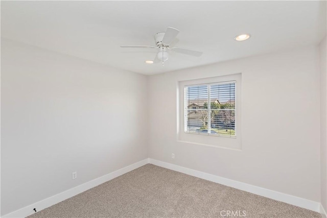 spare room with ceiling fan and carpet flooring