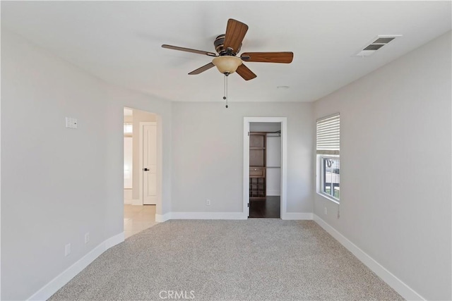 carpeted empty room with ceiling fan