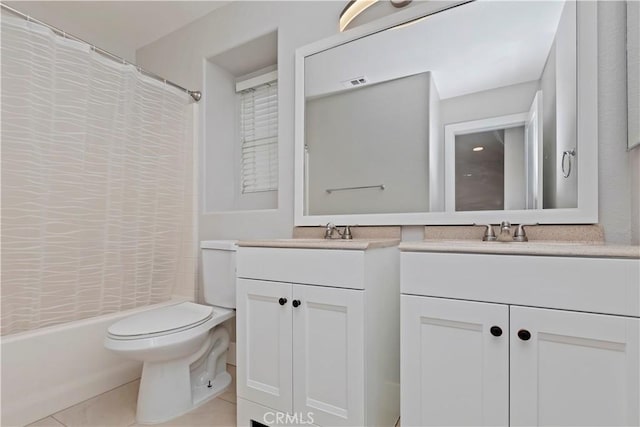 full bathroom with shower / bath combo with shower curtain, tile patterned floors, vanity, and toilet