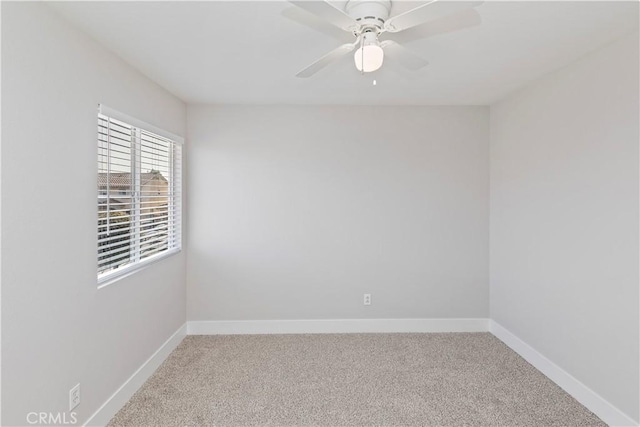 spare room with ceiling fan and carpet